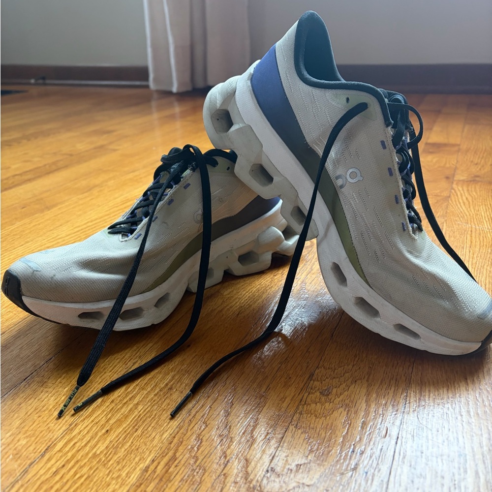 On Running Cream and Black Athletic Shoes